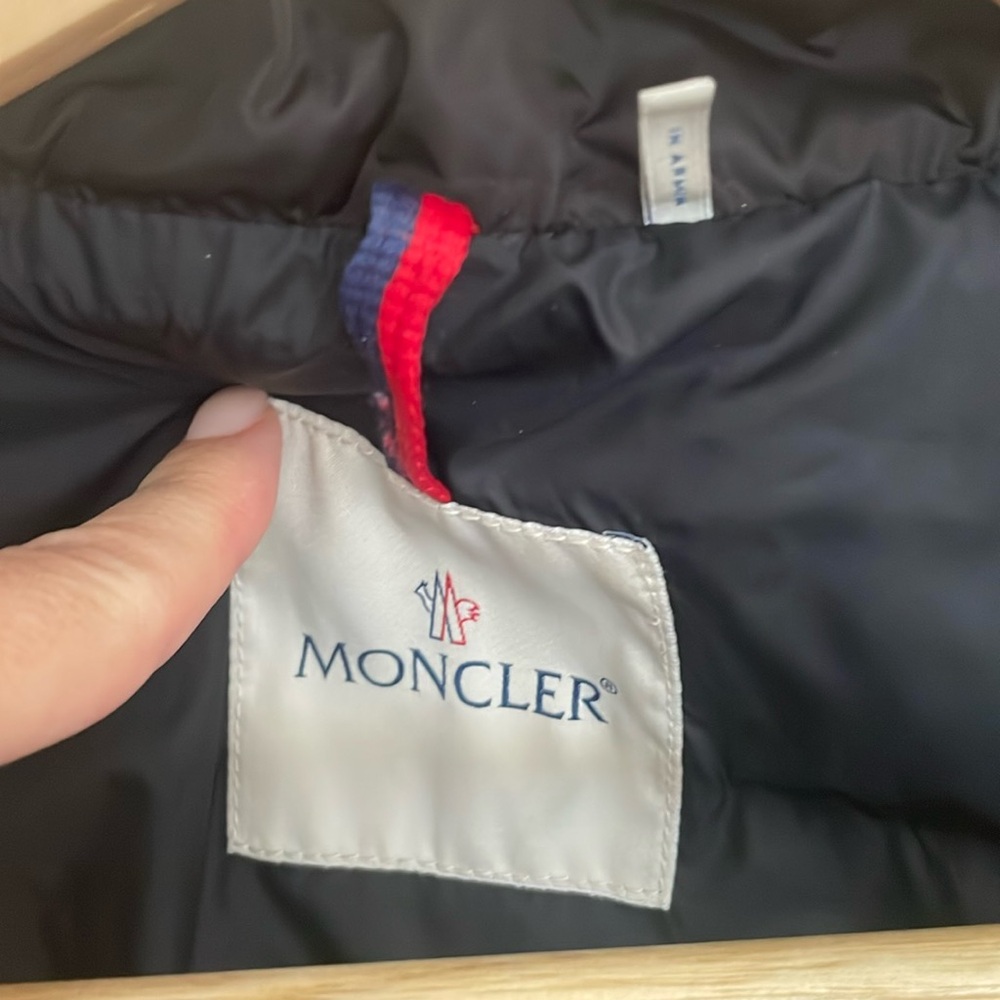 Black Moncler, mid length jacket.